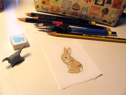 bunny drawing on desk with pencils